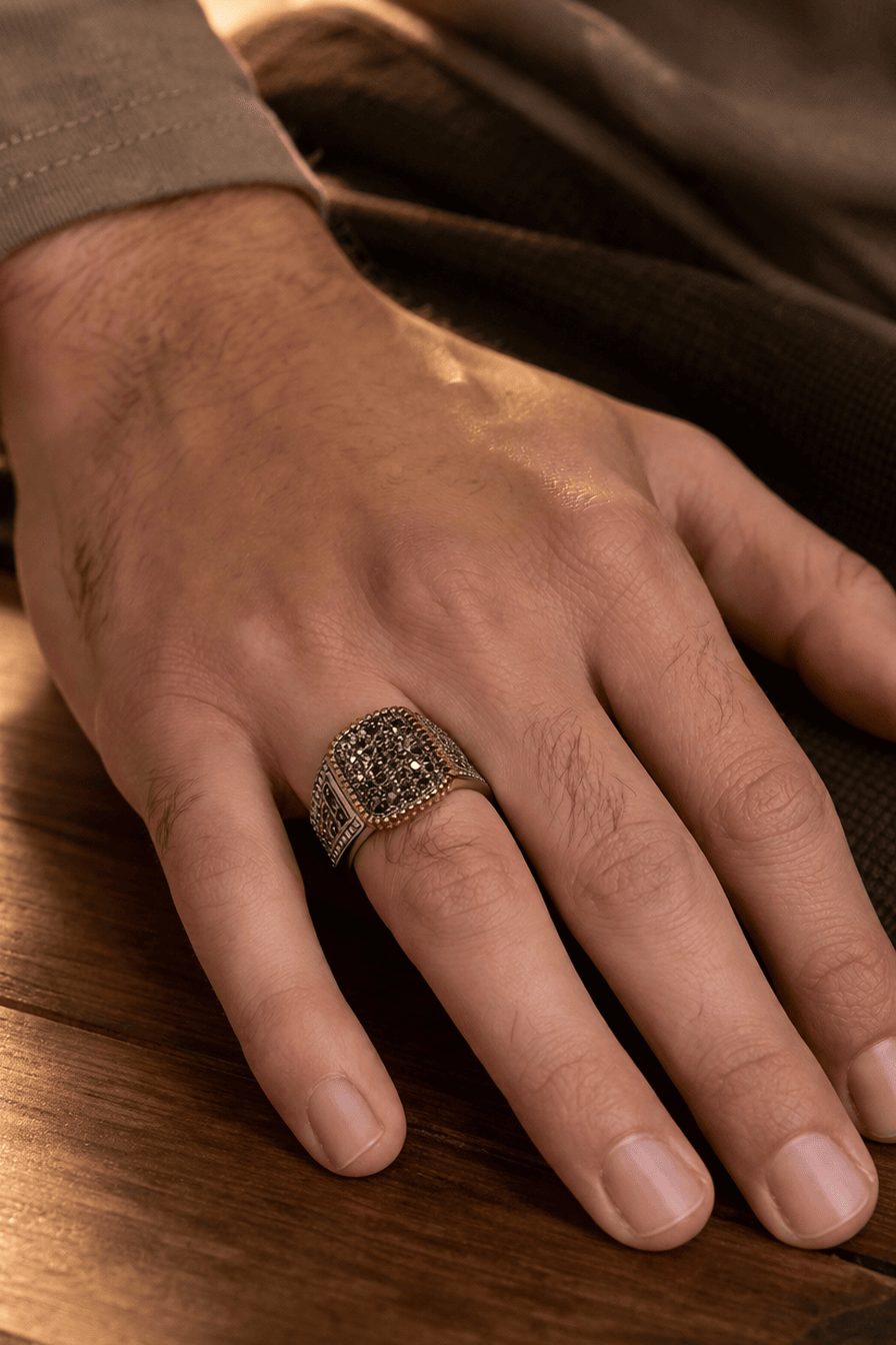 A man wearing a royal Turkish-style gold-tone stainless steel ring with a rectangular cubical zircon centerpiece, ideal for formal occasions.