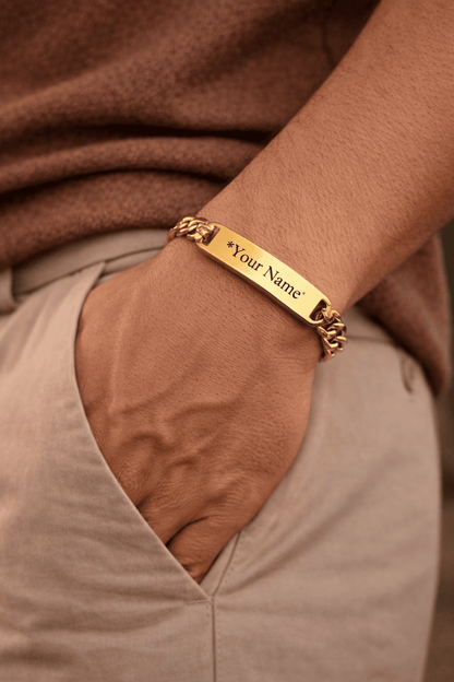 Gold custom name Cuban bracelet for men in Pakistan, engraved ID plate bracelet worn on wrist with warm lighting