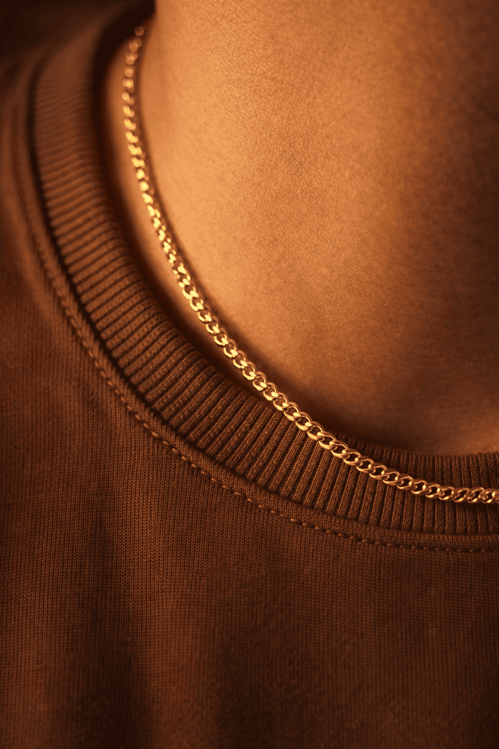 Men gold stainless steel curb chain necklace in Pakistan, polished gold curb link chain worn with brown shirt, waterproof anti rust everyday men jewelry