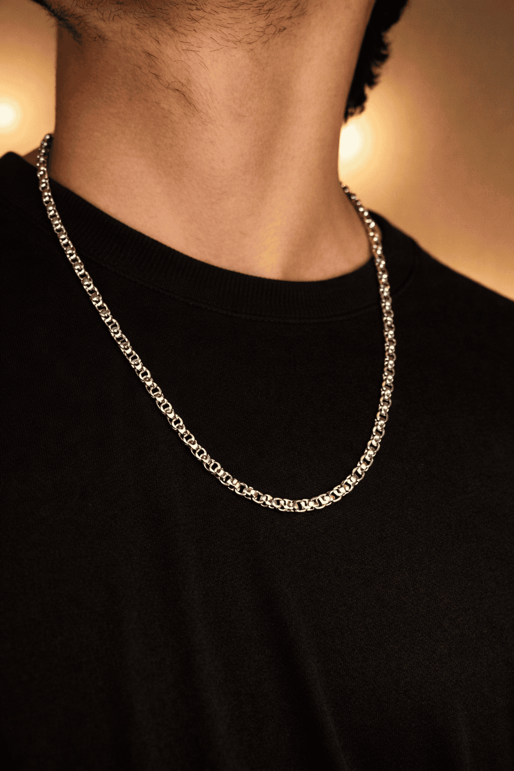 Men stainless steel Byzantine chain necklace in Pakistan, polished silver interlocking link chain worn with black shirt, durable waterproof everyday men jewelry