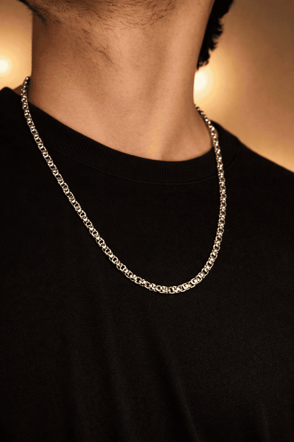 Men stainless steel Byzantine chain necklace in Pakistan, polished silver interlocking link chain worn with black shirt, durable waterproof everyday men jewelry