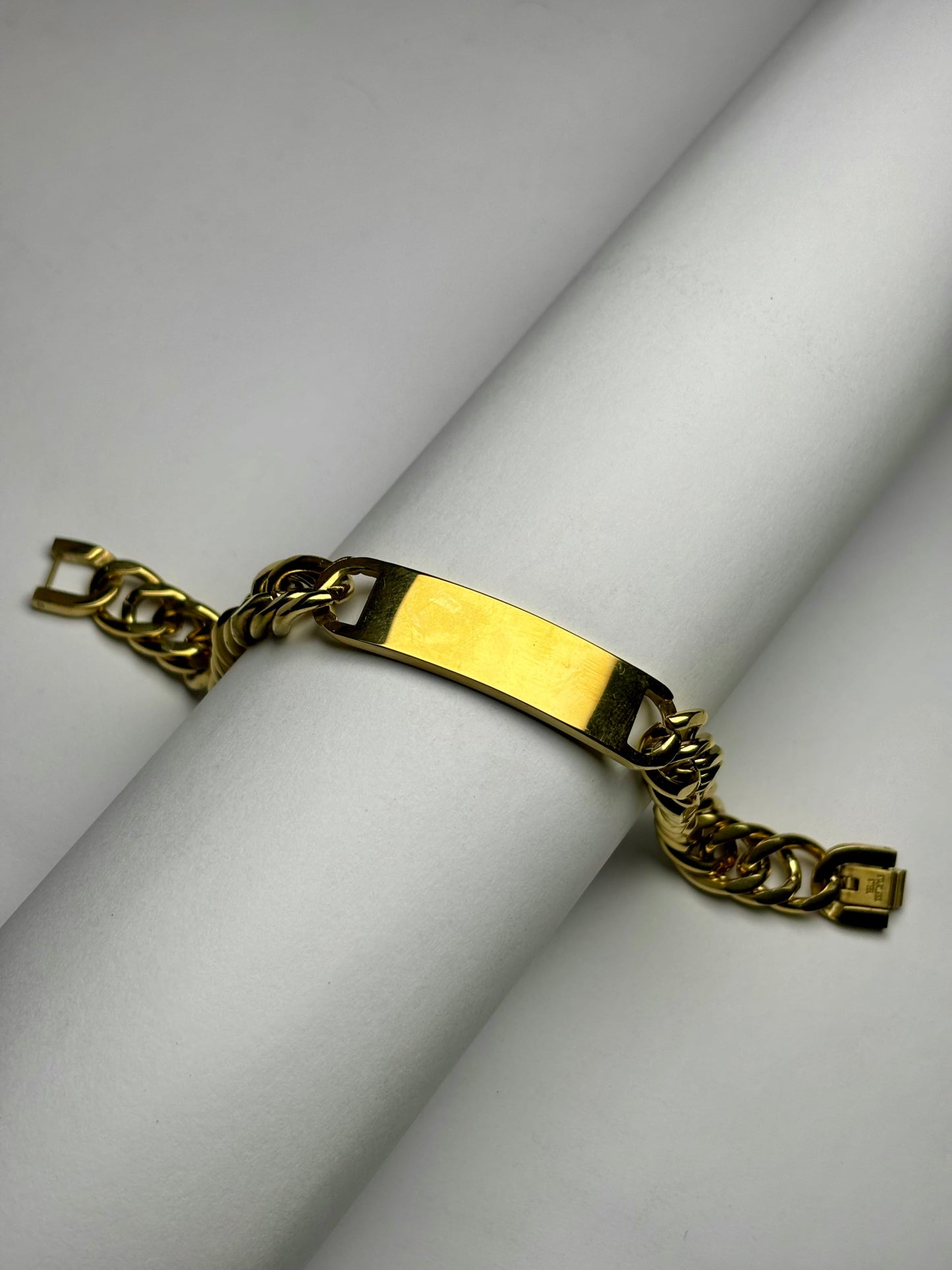 Engraved gold Cuban link bracelet with name plate, stainless steel men’s bracelet product display close-up