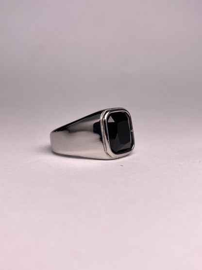 Side perspective of a premium black stone ring showing the mirror-finish stainless steel surface and rectangular agate gemstone.
