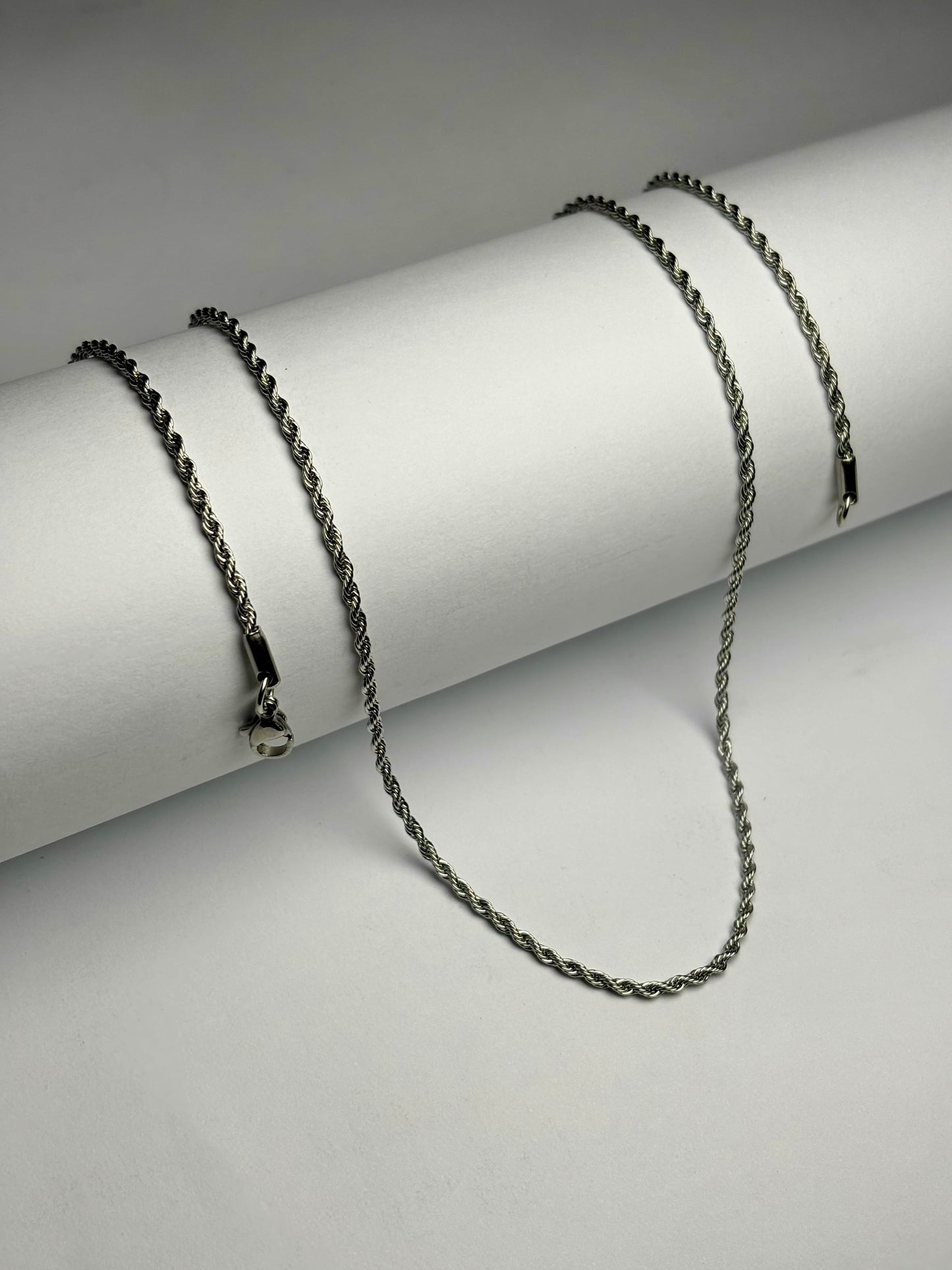 Stainless steel rope chain necklace for men Pakistan, thin polished silver twisted rope link chain with lobster clasp on white background