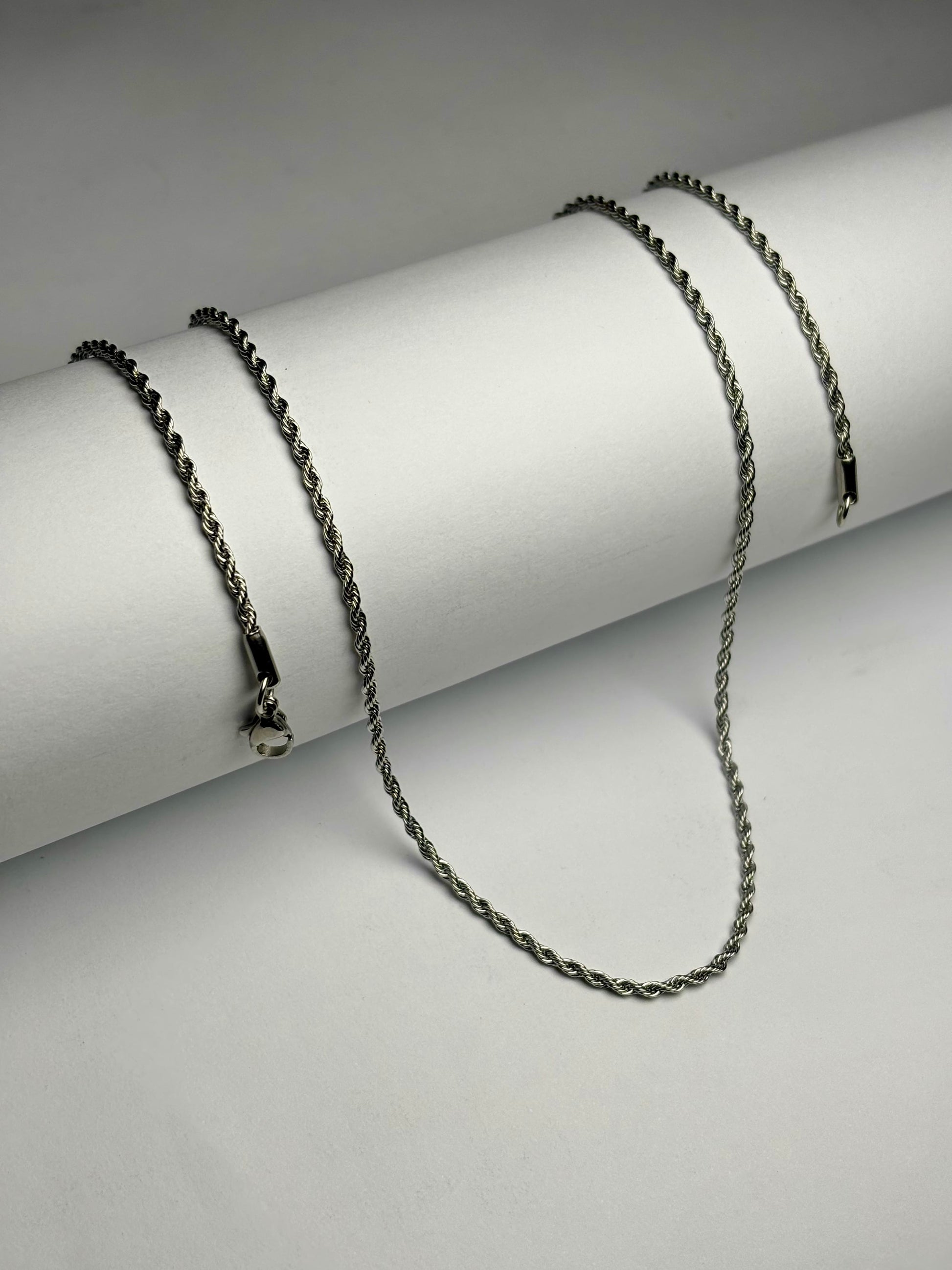 Stainless steel rope chain necklace for men Pakistan, thin polished silver twisted rope link chain with lobster clasp on white background