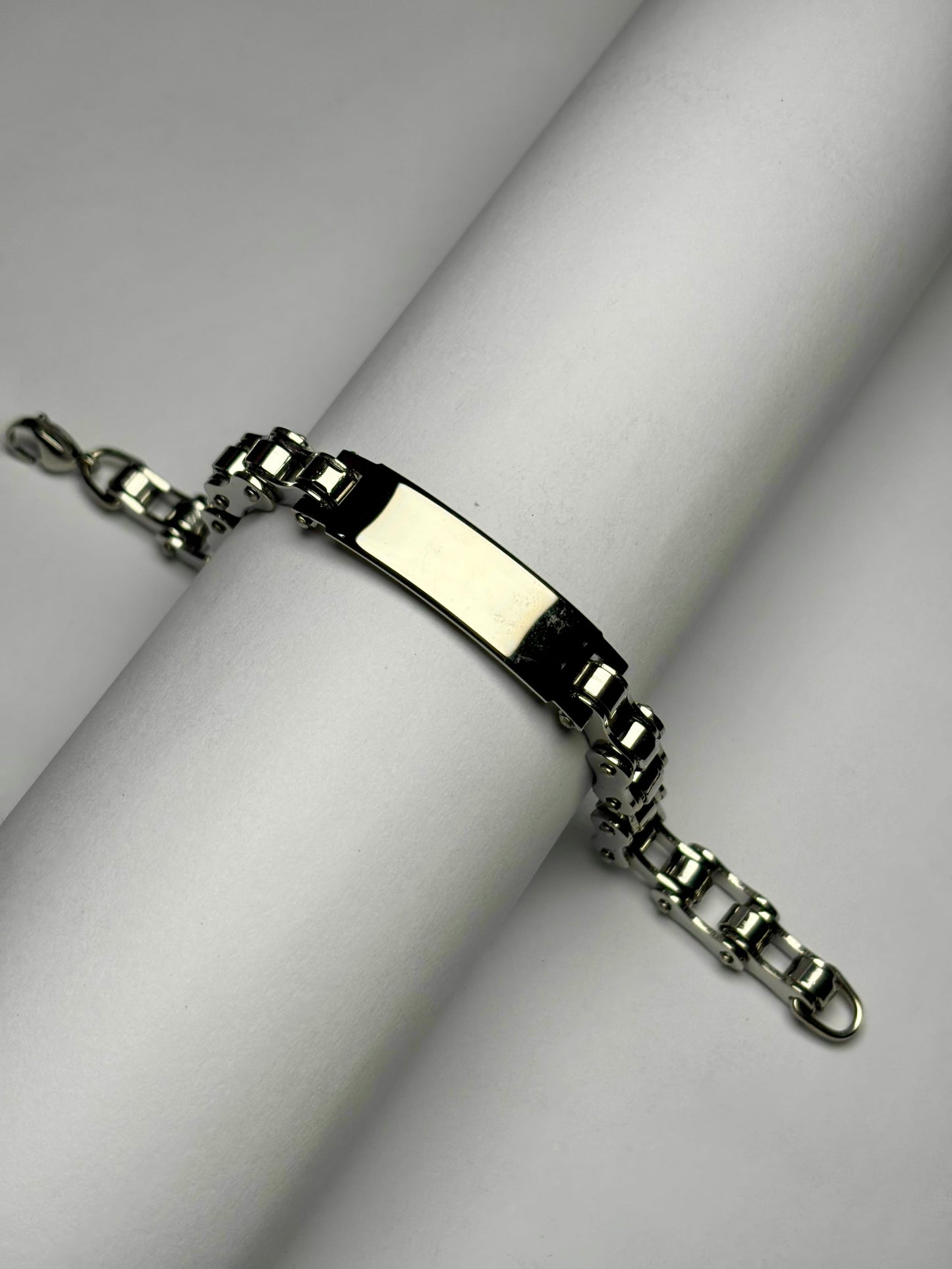 Close-up angled view of men's engraved name plate bracelet showing chain links and customizable plate stainless steel Pakistan