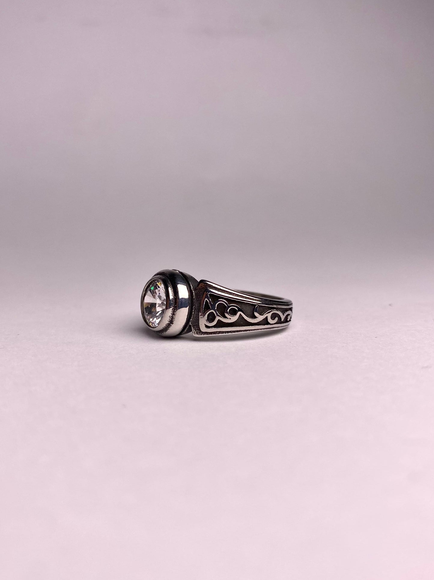 Side view of Noor zircon silver ring for men, polished stainless steel ring with clear round stone, modern and stylish ring available in Pakistan
