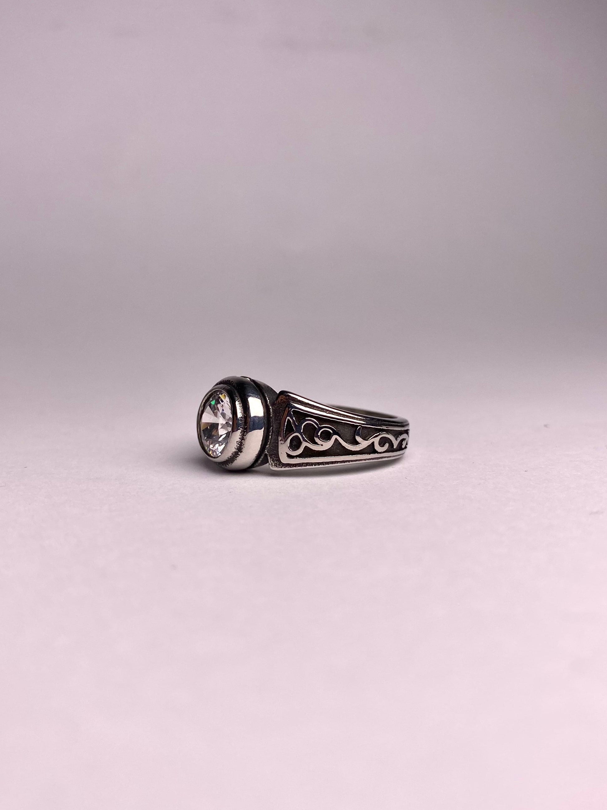 Side view of Noor zircon silver ring for men, polished stainless steel ring with clear round stone, modern and stylish ring available in Pakistan