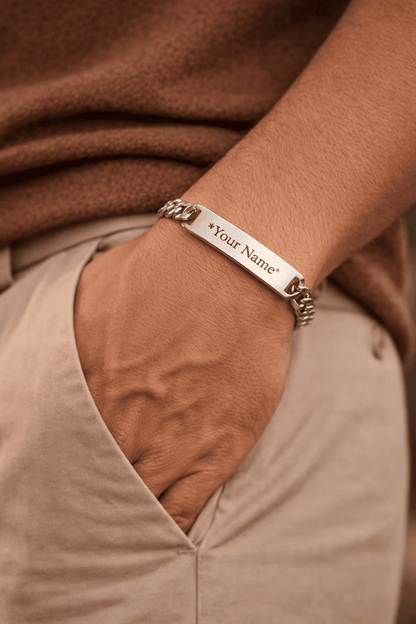 Personalized Cuban link name bracelet for men in Pakistan, engraved stainless steel ID plate bracelet worn on wrist with warm lighting