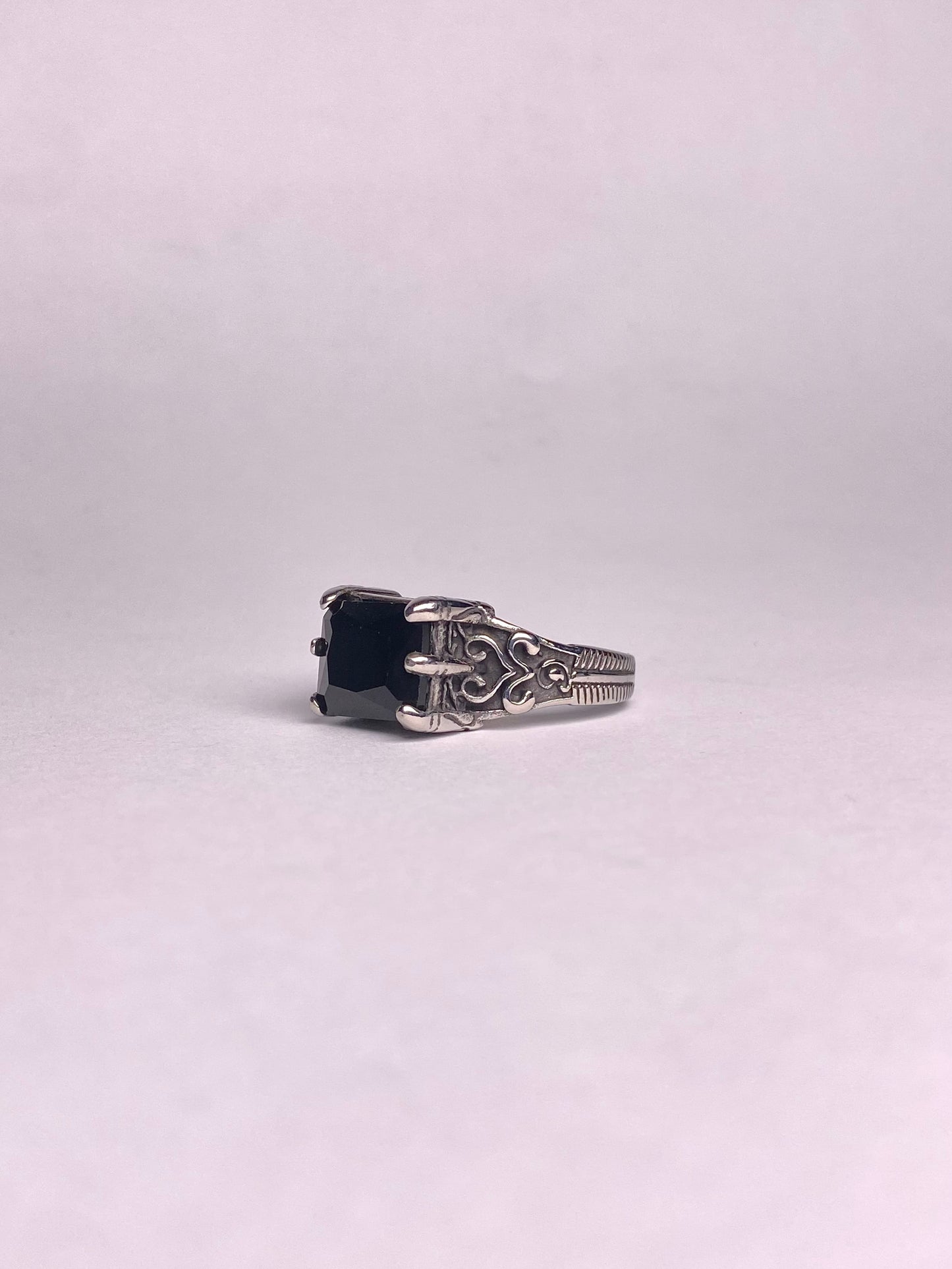 Close-up of a square-cut black Aqeeq gemstone set in a high-quality, rust-proof stainless steel ring for men.