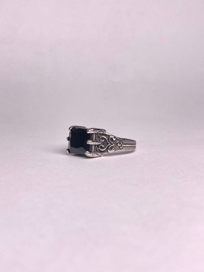 Close-up of a square-cut black Aqeeq gemstone set in a high-quality, rust-proof stainless steel ring for men.