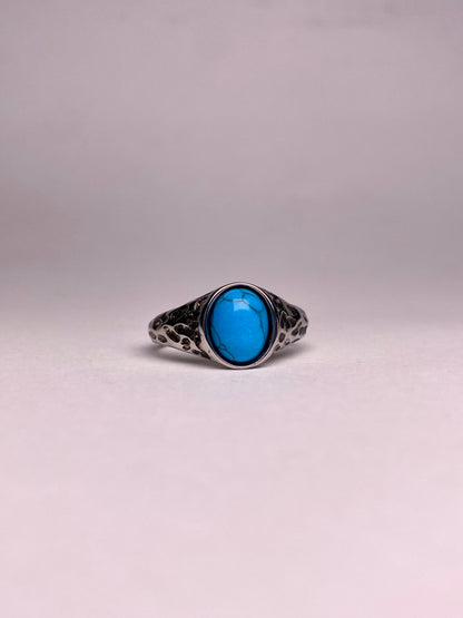 Front view of a high-quality 316L stainless steel ring with a natural blue Feroza stone, ideal for men’s gift items.
